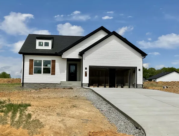 a front view of a house with yard and garage