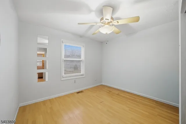 a view of a room with a window and ceiling fan