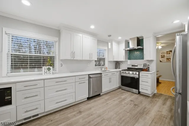 a kitchen with stainless steel appliances granite countertop a stove and a sink