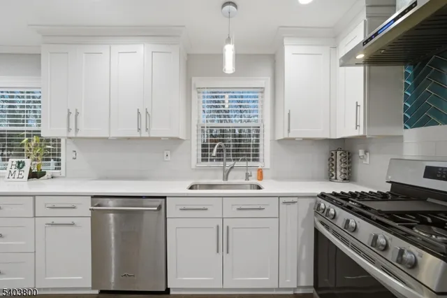 a kitchen with white cabinets and white appliances