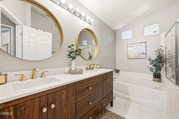 a bathroom with a double vanity sink and a mirror