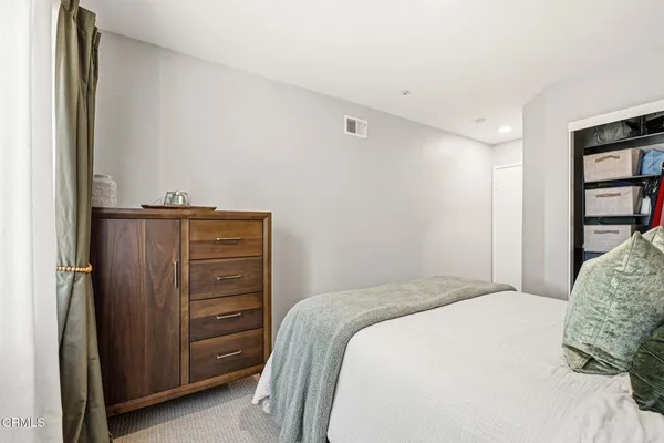 a bedroom with a bed and a closet