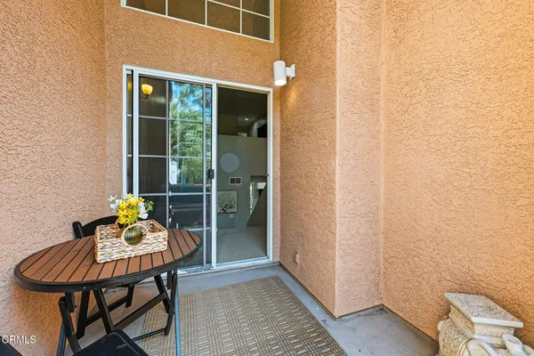 a balcony with table and chairs
