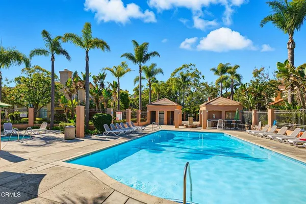 a view of a house with swimming pool and sitting area