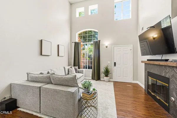 a living room with furniture a fireplace and a flat screen tv