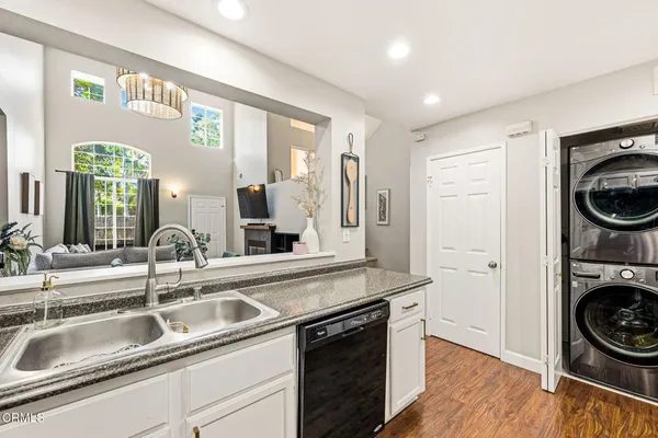 a kitchen with a sink and a stove top oven