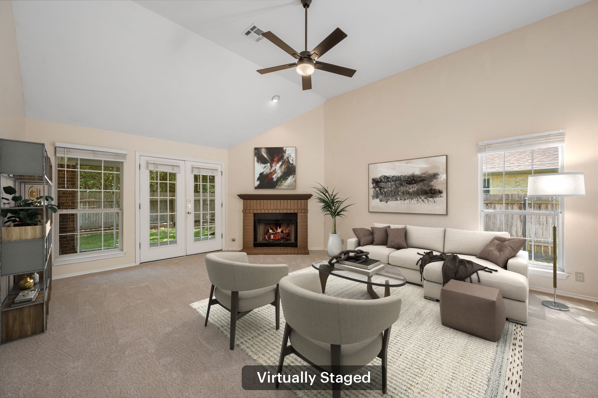 1600 Colton Way Cedar Park, TX 78613 - Photo 16 of 34 A spacious living room features vaulted ceilings, a cozy fireplace, and direct backyard access through French doors.