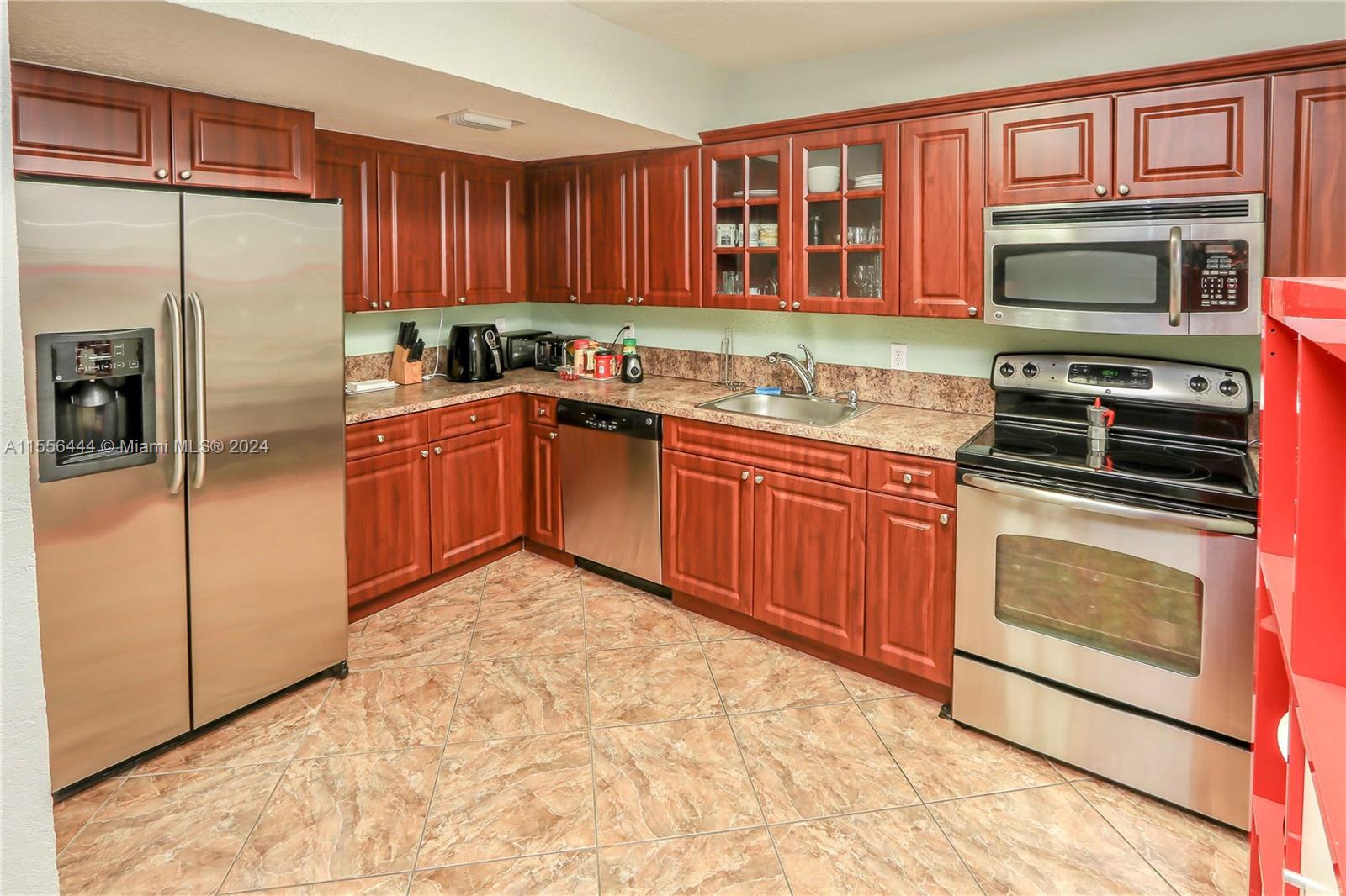 5635 Southwest 5th Terrace Miami, FL 33134 - Photo 11 of 28 a kitchen with stainless steel appliances granite countertop a refrigerator stove and microwave