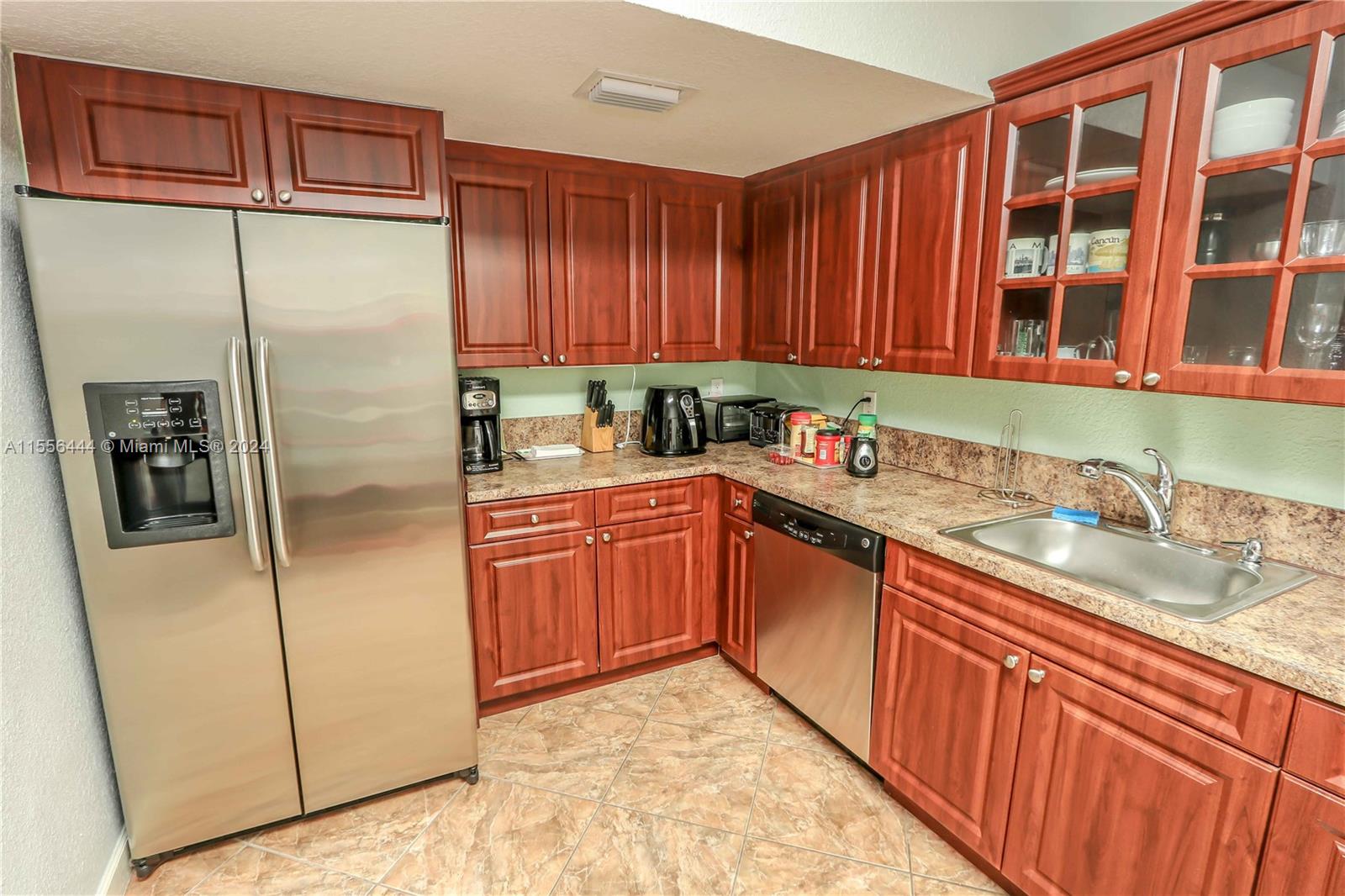 5635 Southwest 5th Terrace Miami, FL 33134 - Photo 13 of 28 a kitchen with stainless steel appliances granite countertop a refrigerator and a sink