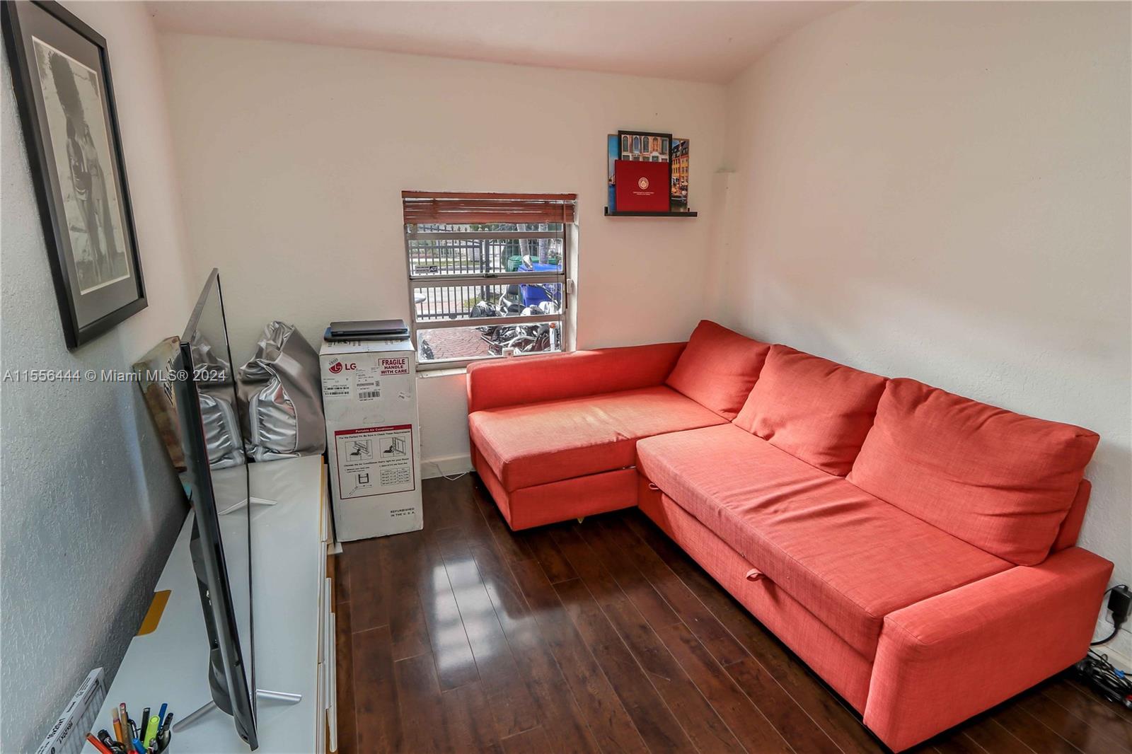 5635 Southwest 5th Terrace Miami, FL 33134 - Photo 15 of 28 a blue couch sitting in a living room with a rug