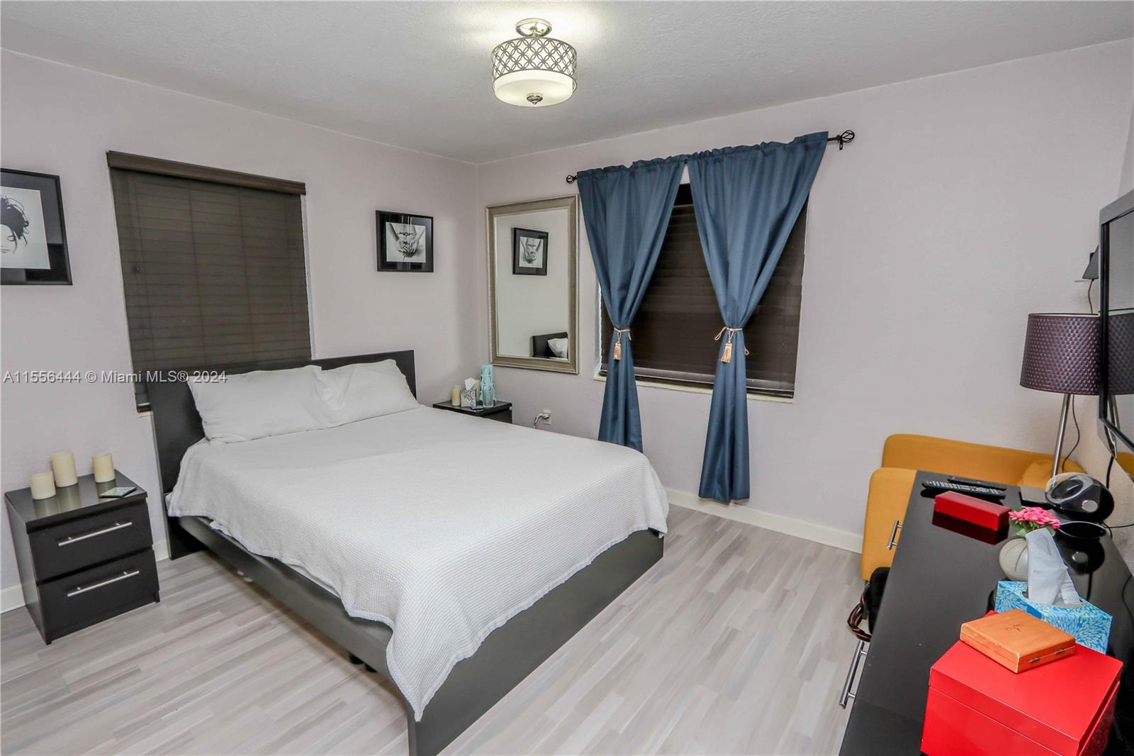 5635 Southwest 5th Terrace Miami, FL 33134 - Photo 20 of 28 a bedroom with a bed and a flat tv screen on a dresser