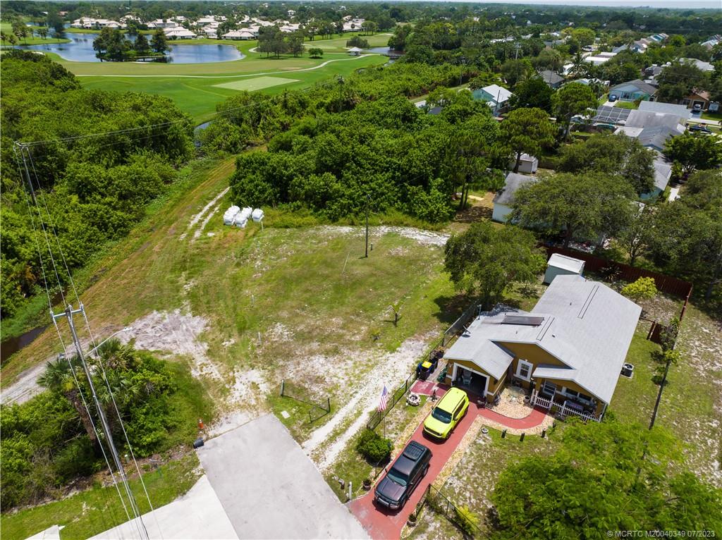 Tbd Southeast Primrose Way Stuart, FL 34997 - Photo 5 of 7 an aerial view of residential houses with outdoor space and trees
