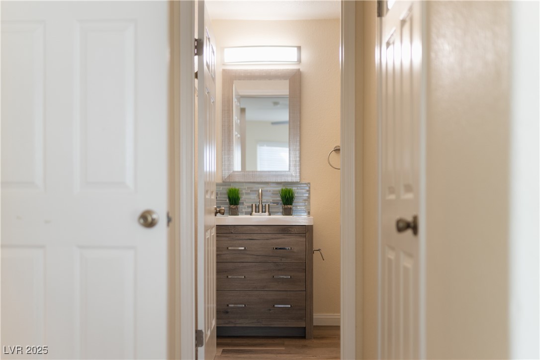 3318 North Decatur Boulevard, Unit 2143 Las Vegas, NV 89130 - Photo 14 of 34 Half bath with vanity and dark wood-style floors