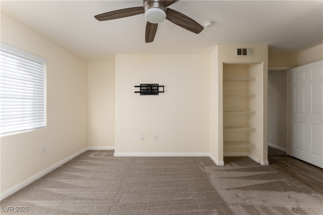 3318 North Decatur Boulevard, Unit 2143 Las Vegas, NV 89130 - Photo 19 of 34 Unfurnished bedroom featuring ceiling fan and light colored carpet