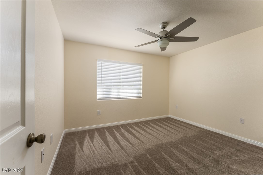 3318 North Decatur Boulevard, Unit 2143 Las Vegas, NV 89130 - Photo 20 of 34 Unfurnished room featuring dark colored carpet and a ceiling fan