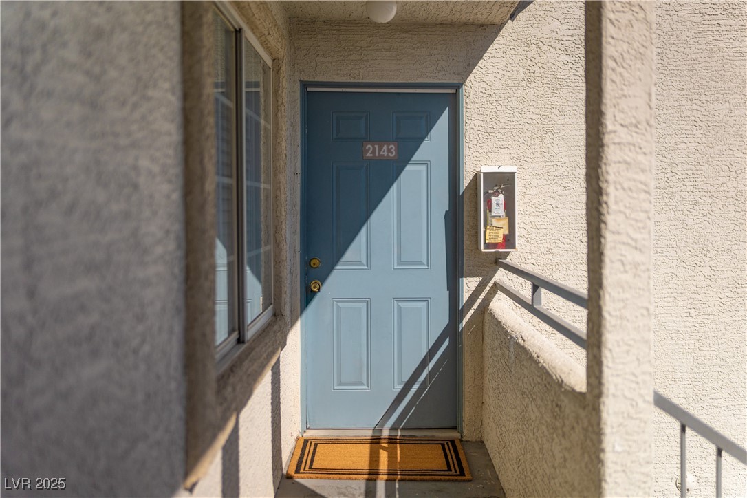 3318 North Decatur Boulevard, Unit 2143 Las Vegas, NV 89130 - Photo 26 of 34 Entrance to property featuring stucco siding