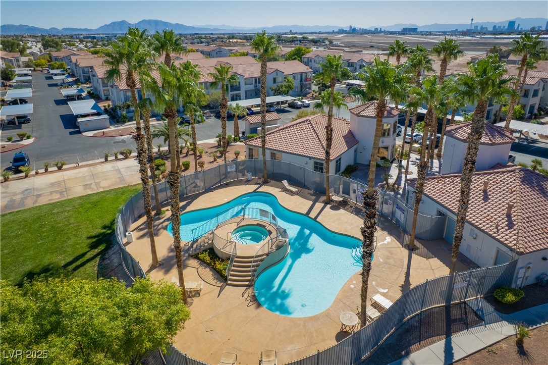3318 North Decatur Boulevard, Unit 2143 Las Vegas, NV 89130 - Photo 28 of 34 Community pool featuring a patio, a hot tub, a residential view, and a mountain view