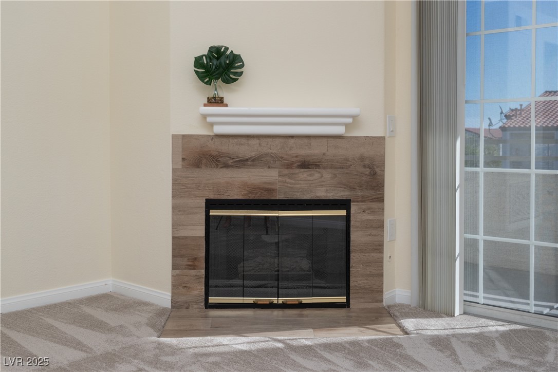 3318 North Decatur Boulevard, Unit 2143 Las Vegas, NV 89130 - Photo 6 of 34 Detailed view of a tiled fireplace and carpet flooring