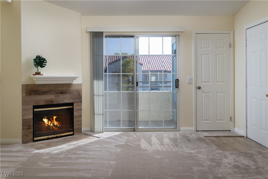 3318 North Decatur Boulevard, Unit 2143 Las Vegas, NV 89130 - Photo 7 of 34 Doorway to outside with a premium fireplace and carpet flooring