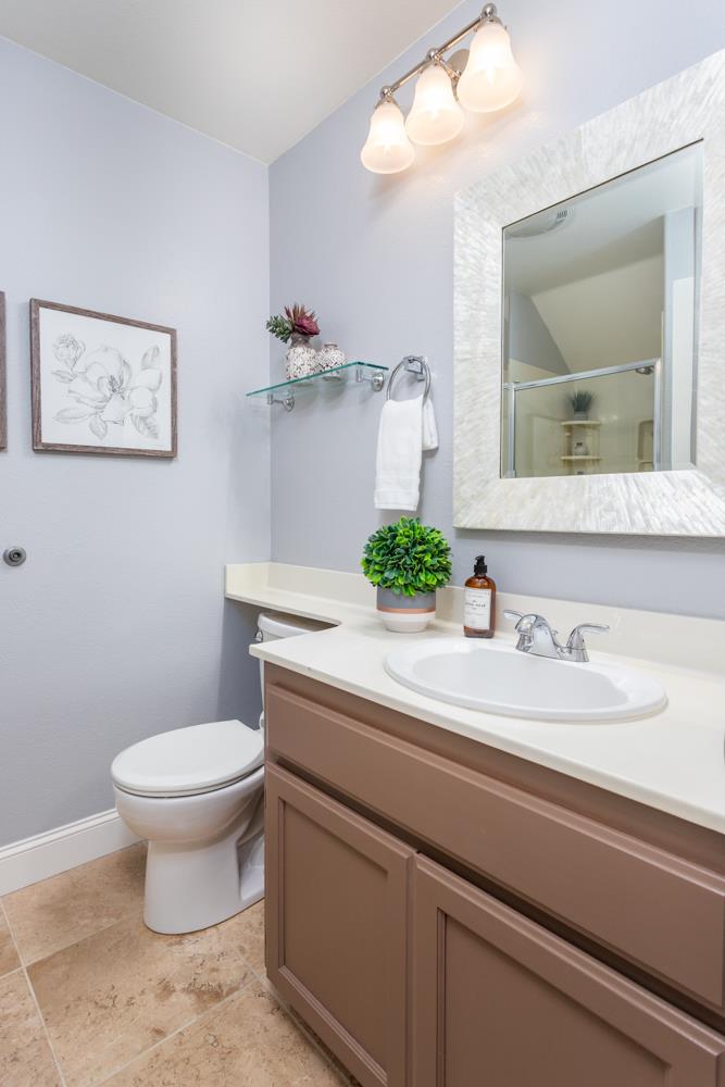30152 Bridgeview Way Hayward, CA 94544 - Photo 17 of 37 a bathroom with a granite countertop toilet sink and mirror