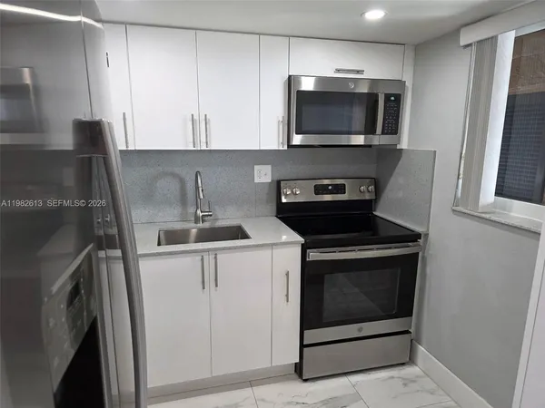 a kitchen with a sink and cabinets