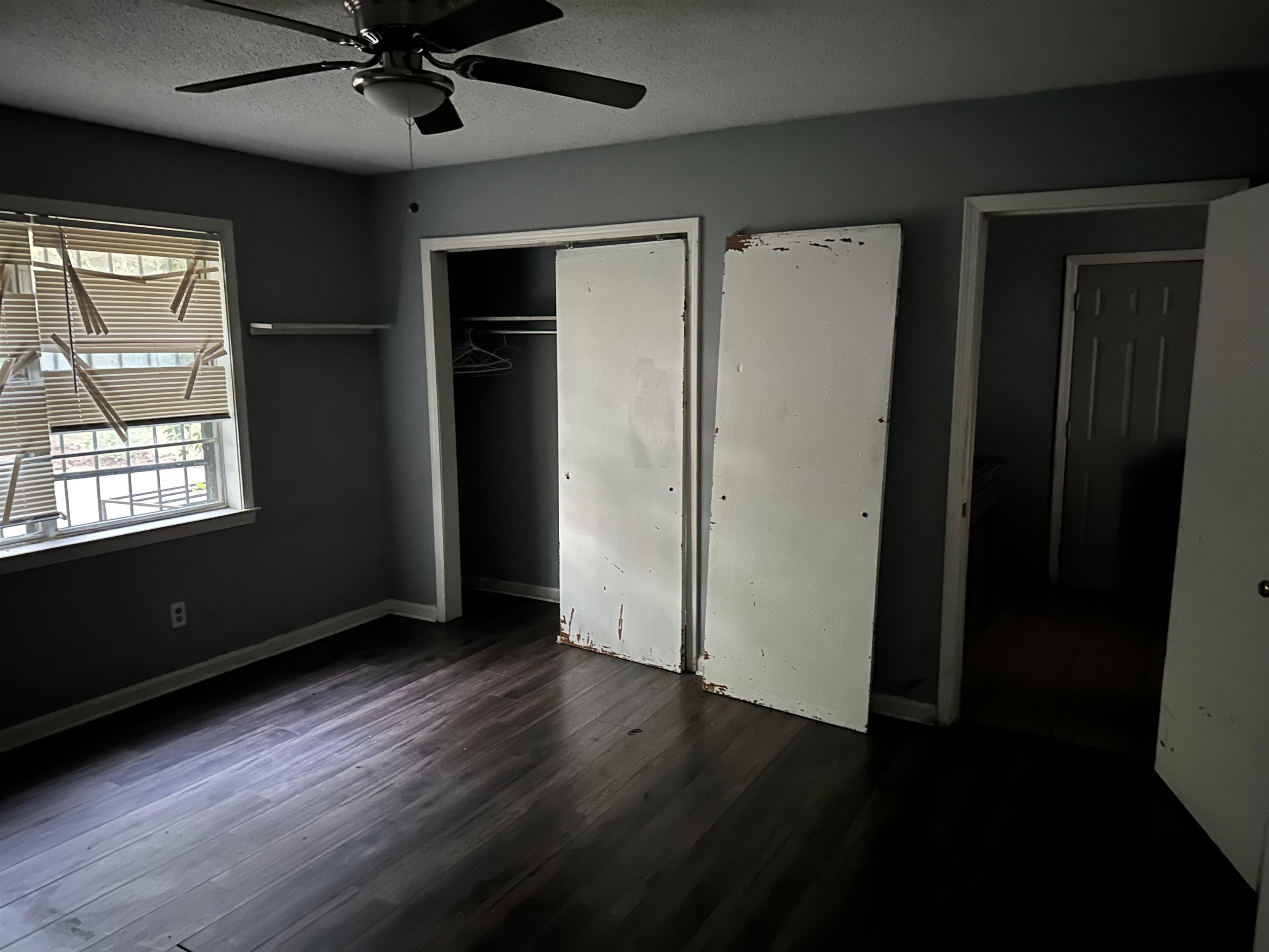 4850 Applestone Street Memphis, TN 38109 - Photo 5 of 9 a view of an empty room with wooden floor and a window