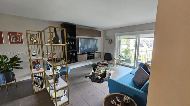 a view of a livingroom with workspace and a couch