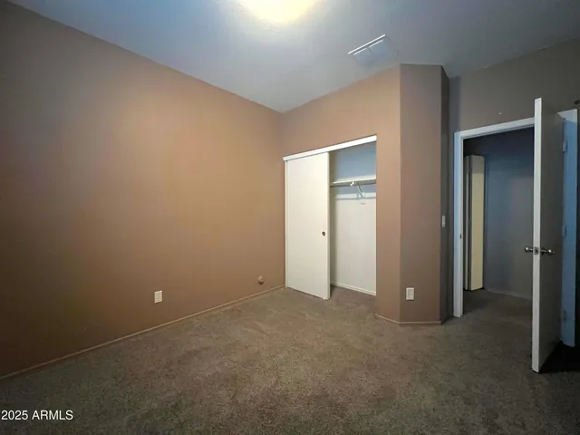 an empty room with closet area