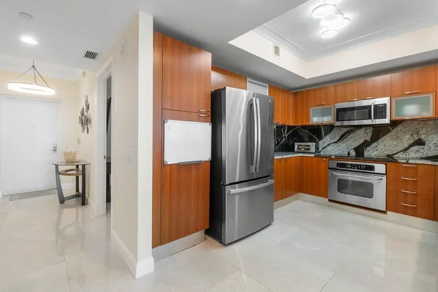 a kitchen with stainless steel appliances granite countertop a sink and a wooden cabinets