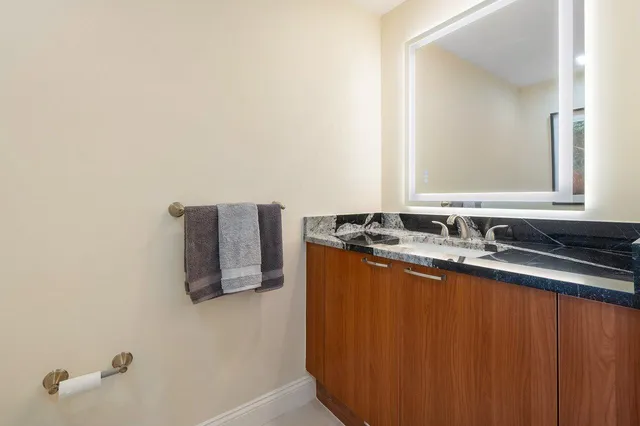 a kitchen with stainless steel appliances granite countertop a sink and a refrigerator