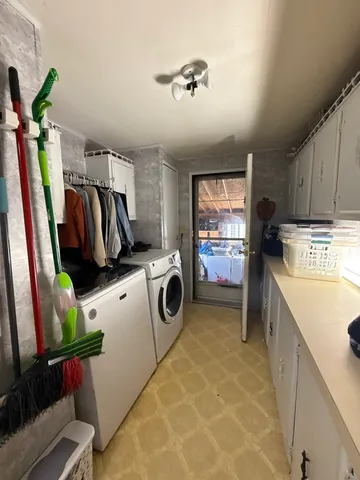 a utility room with sink dryer and washer