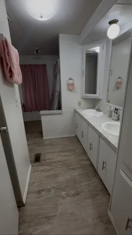 a bathroom with a sink a toilet and mirror