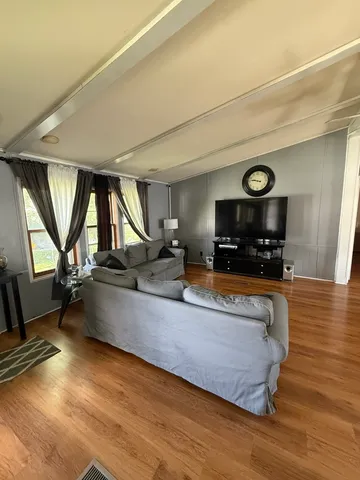 a view of living room with furniture and window