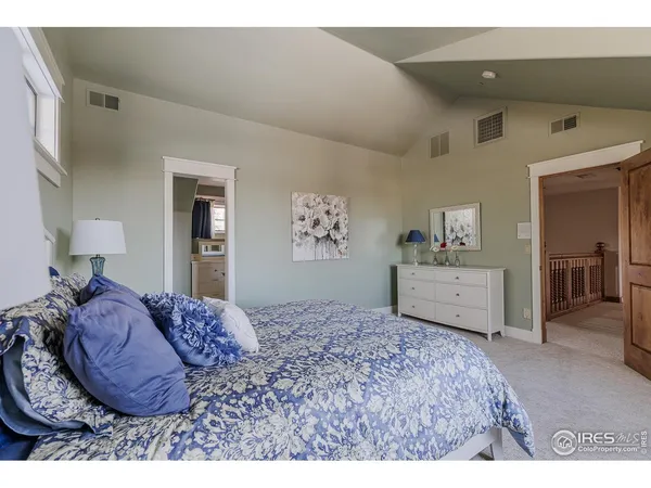 a bedroom with a bed and dresser