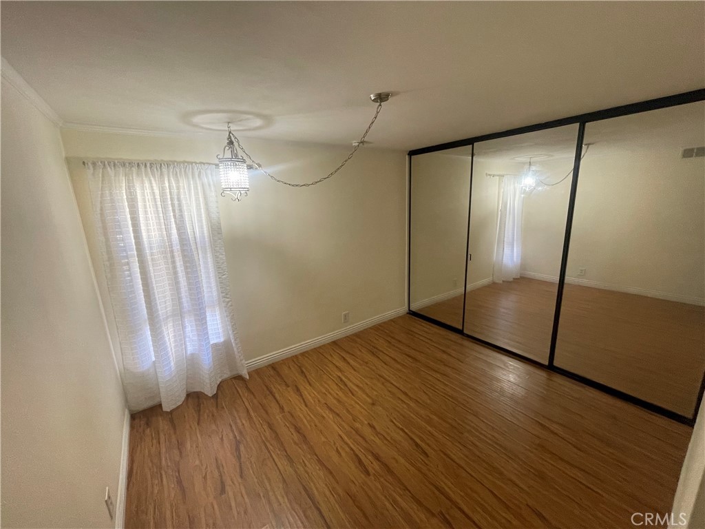124 Tangelo, Unit 390 Irvine, CA 92618 - Photo 8 of 9 an empty room with wooden floor and windows