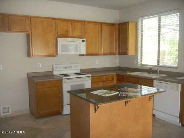 844 South Roca Court Gilbert, AZ 85296 - Photo 2 of 14 a kitchen with a sink stove and cabinets