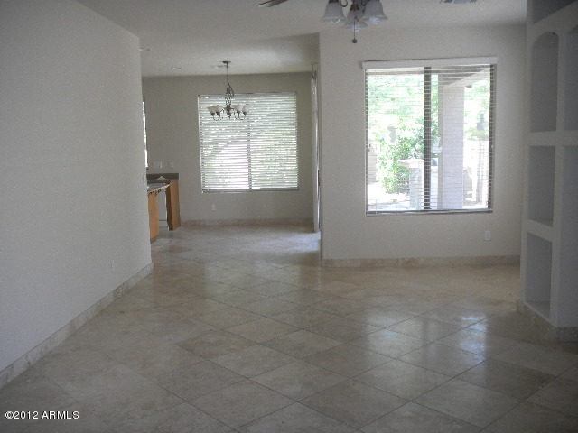 844 South Roca Court Gilbert, AZ 85296 - Photo 4 of 14 an empty room with windows and natural light