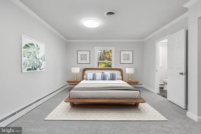 a bedroom with a bed and painting on the wall