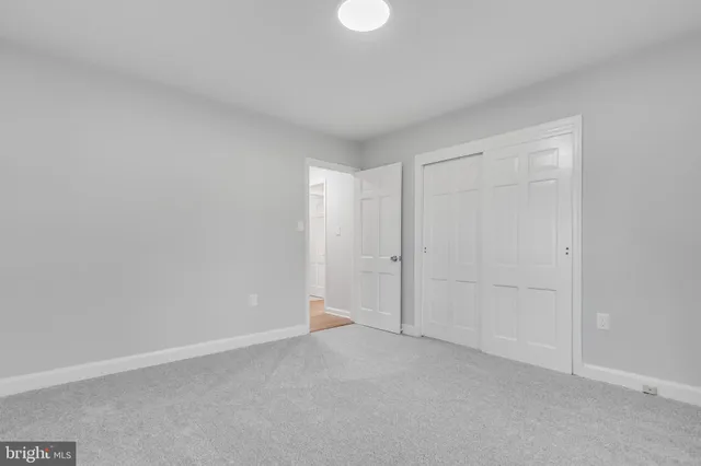 a view of an empty room and closet area