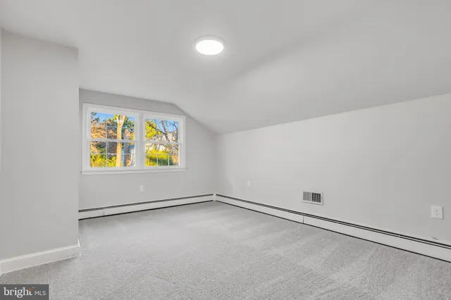 an empty room with windows and entrance