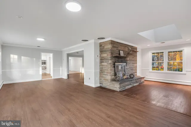 a view of an empty room with a fireplace and a window