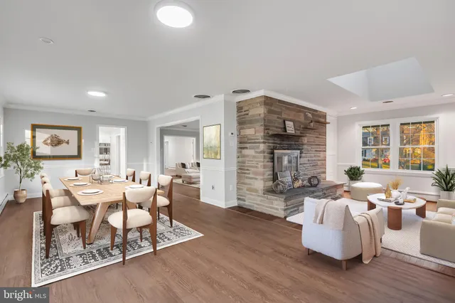 a living room with fireplace furniture and wooden floor