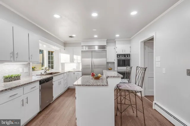 a large kitchen with kitchen island a large island in the center