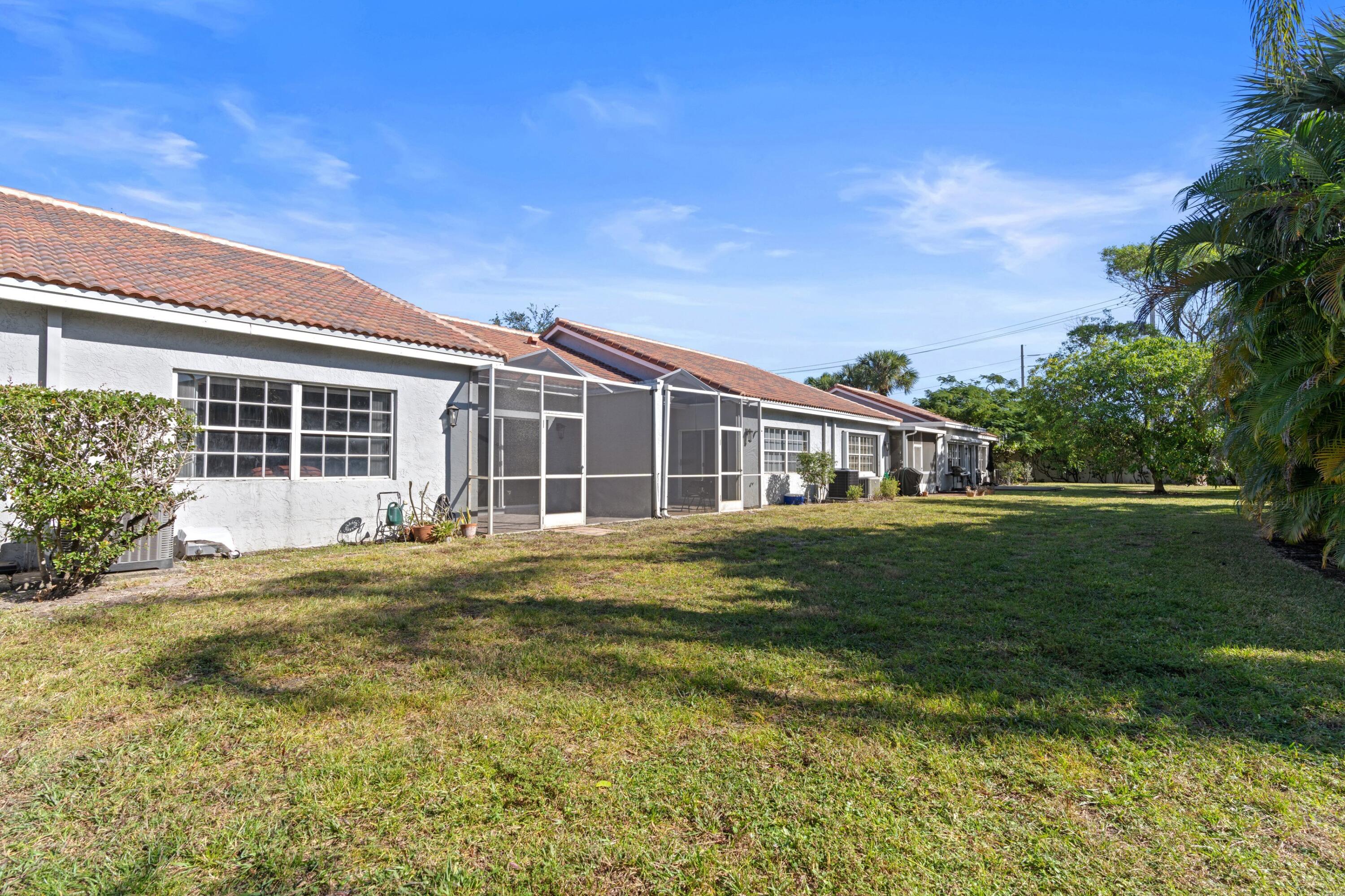 5140 Sabal Gardens Lane, Unit 2 Boca Raton, FL 33487 - Photo 15 of 34 a front view of a house with a garden