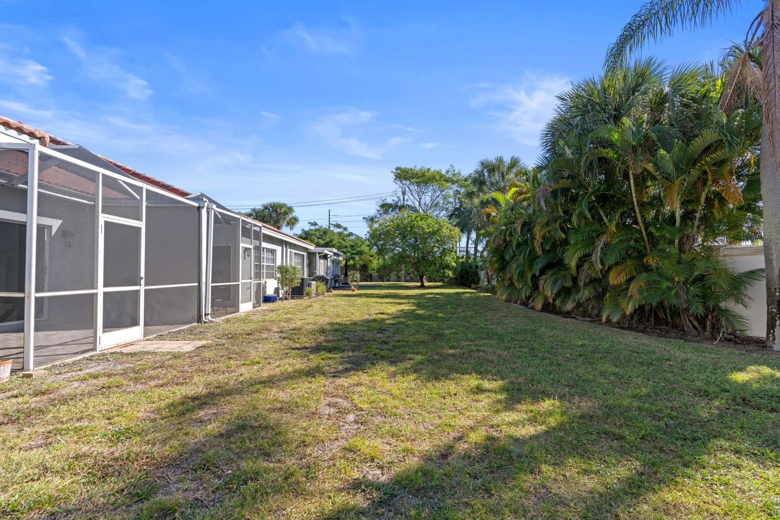 5140 Sabal Gardens Lane, Unit 2 Boca Raton, FL 33487 - Photo 16 of 34 a view of a yard with plants and tree