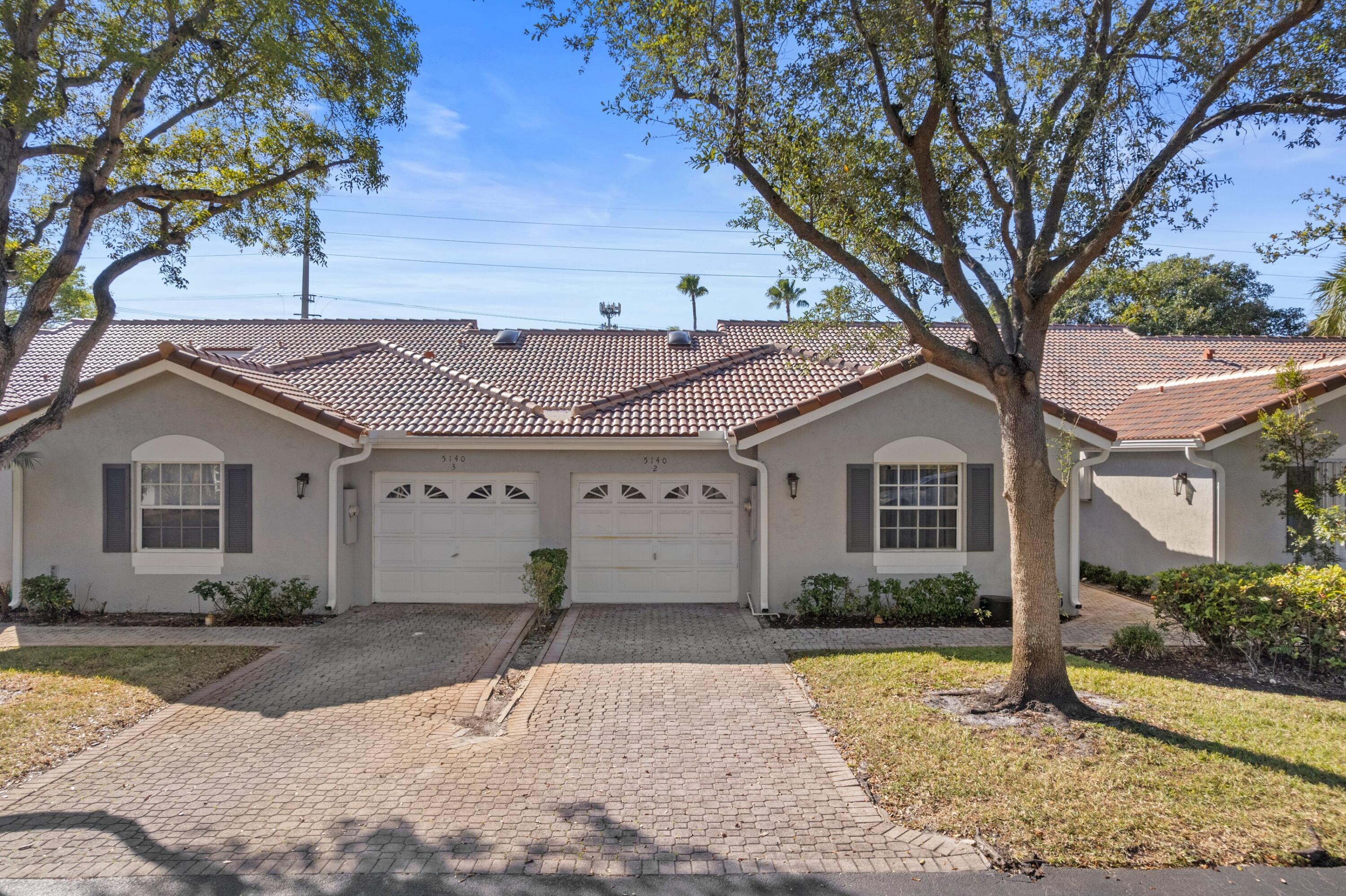 5140 Sabal Gardens Lane, Unit 2 Boca Raton, FL 33487 - Photo 17 of 34 a front view of a house with garden