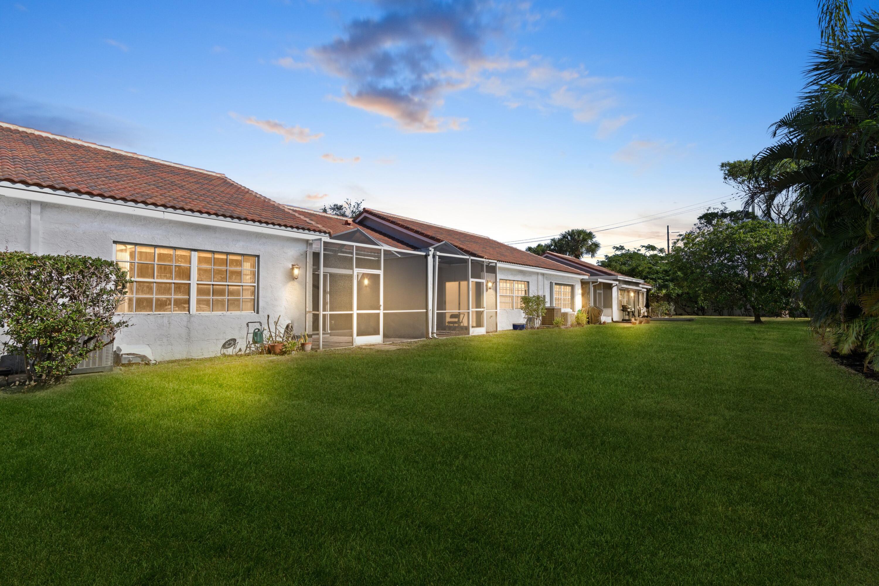 5140 Sabal Gardens Lane, Unit 2 Boca Raton, FL 33487 - Photo 3 of 34 a front view of house with yard and green space