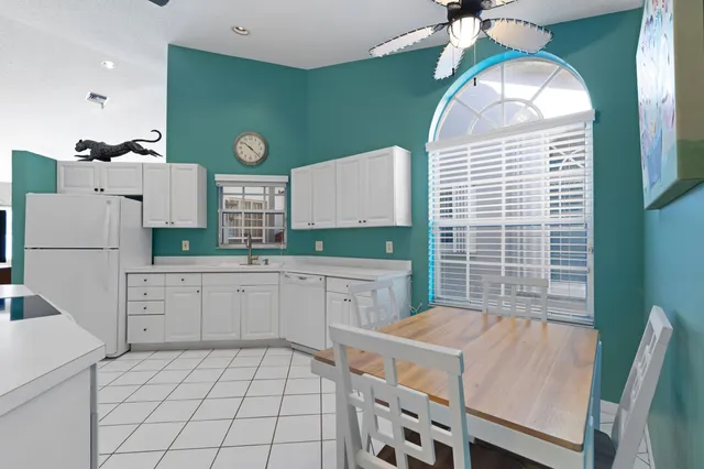 a kitchen with a refrigerator and a stove