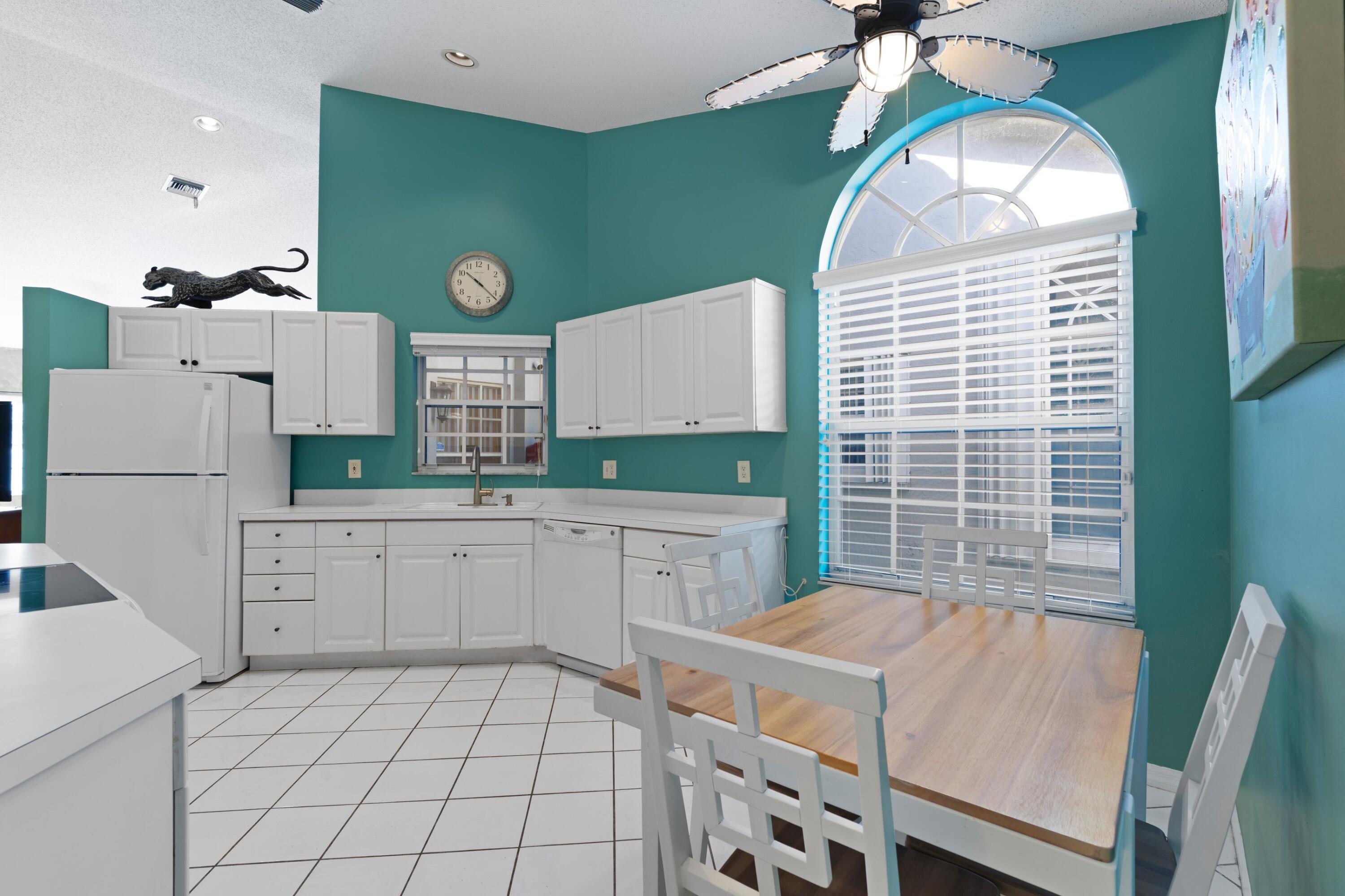 5140 Sabal Gardens Lane, Unit 2 Boca Raton, FL 33487 - Photo 4 of 34 a kitchen with a refrigerator and a stove