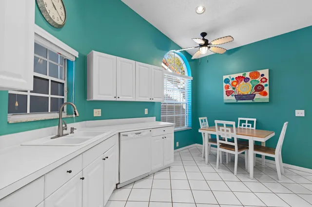 a kitchen with a cabinets and chairs